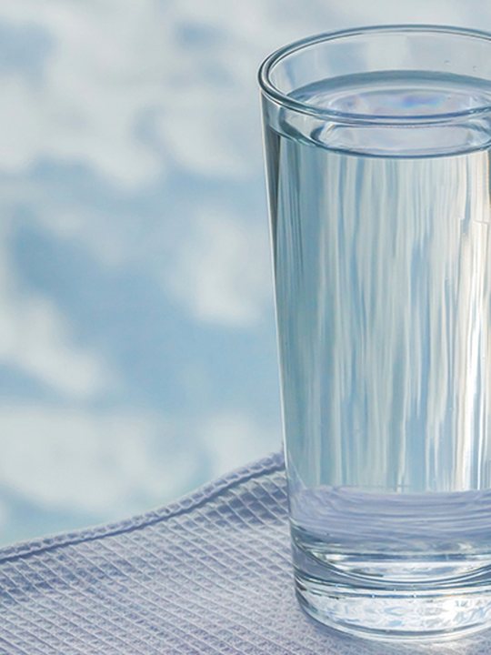 A glass of clear drinking water, advertising a free in-home water test by Jones Air & Water