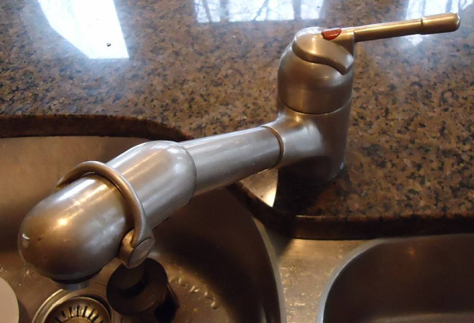 A kitchen faucet about to be repaired.